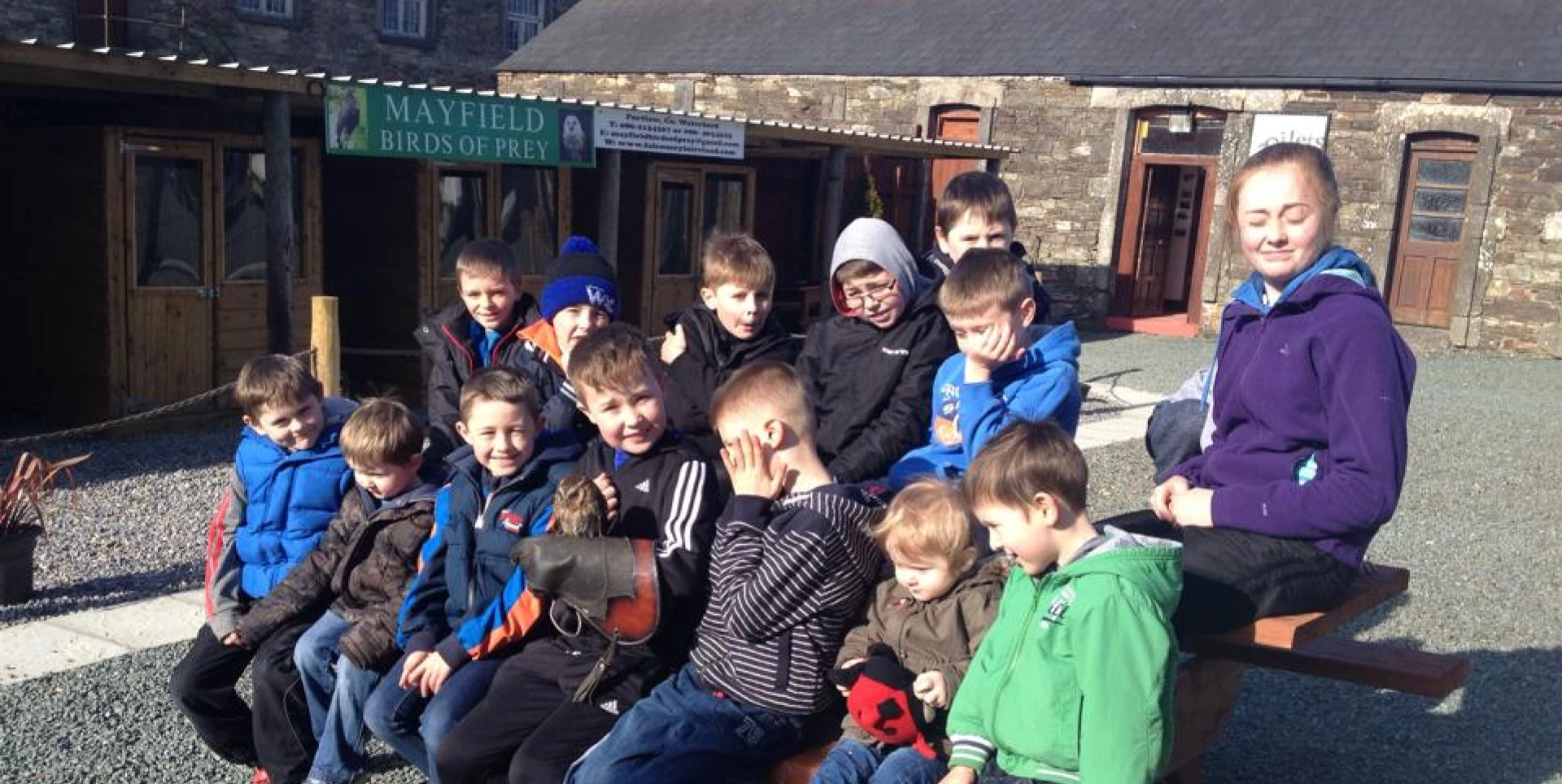 A group of people posing together in a rocky garden.